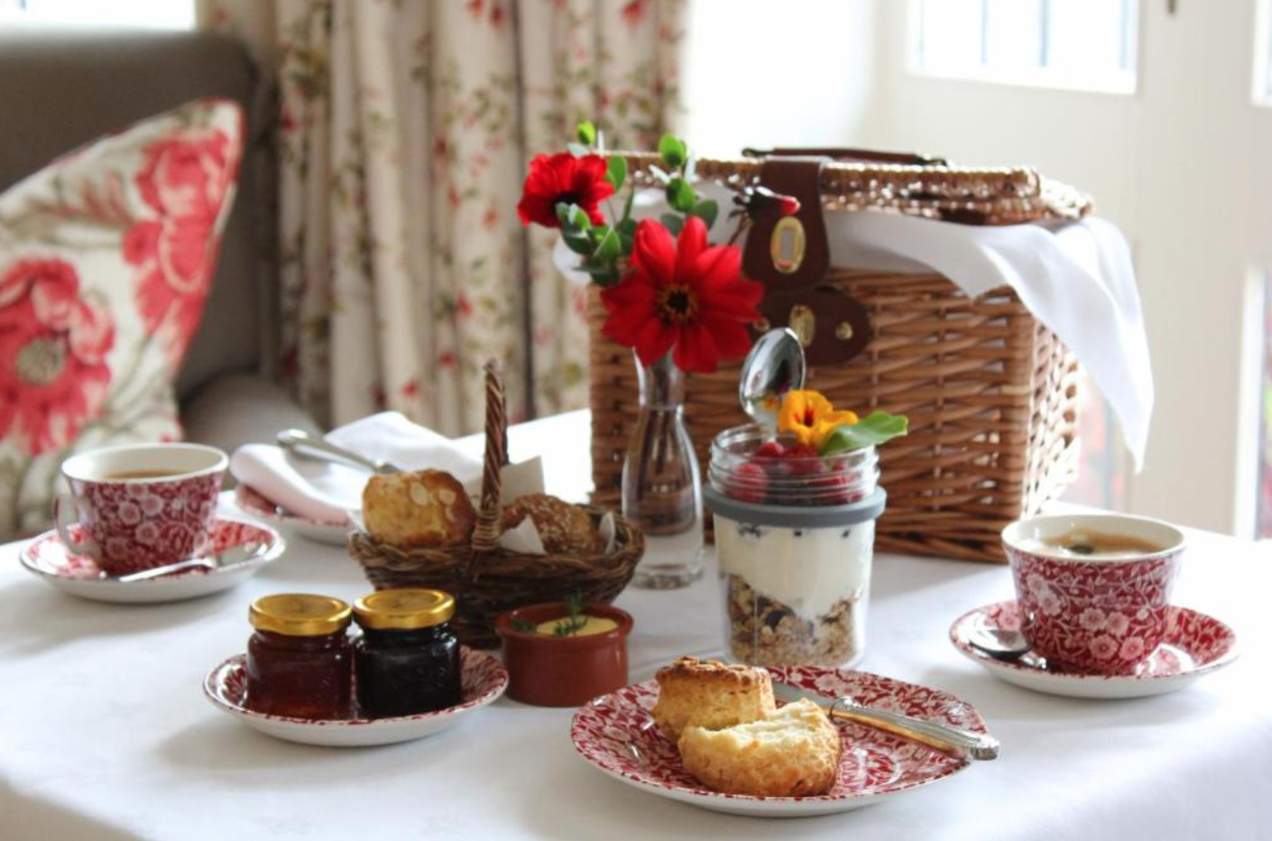 Breakfast with scones, granola and tea served in a guest room